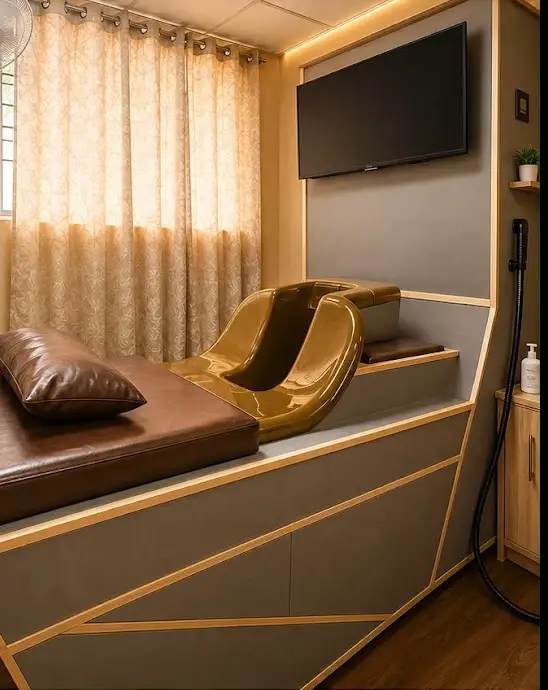 Private hydrotherapy room with a cushioned bed and warm curtained window