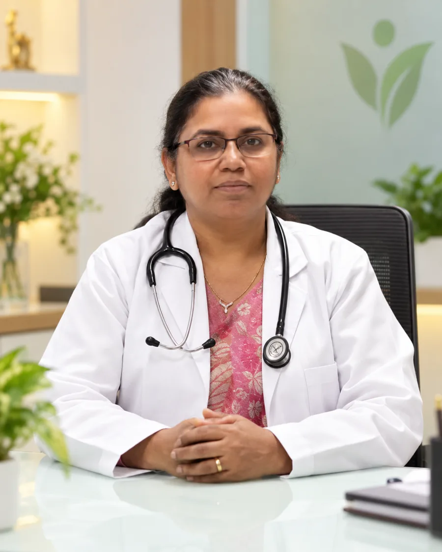 Portrait of the lead practitioner at VitalZone, seated at her consulting desk